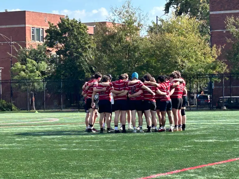 Loyola team huddle on campus field